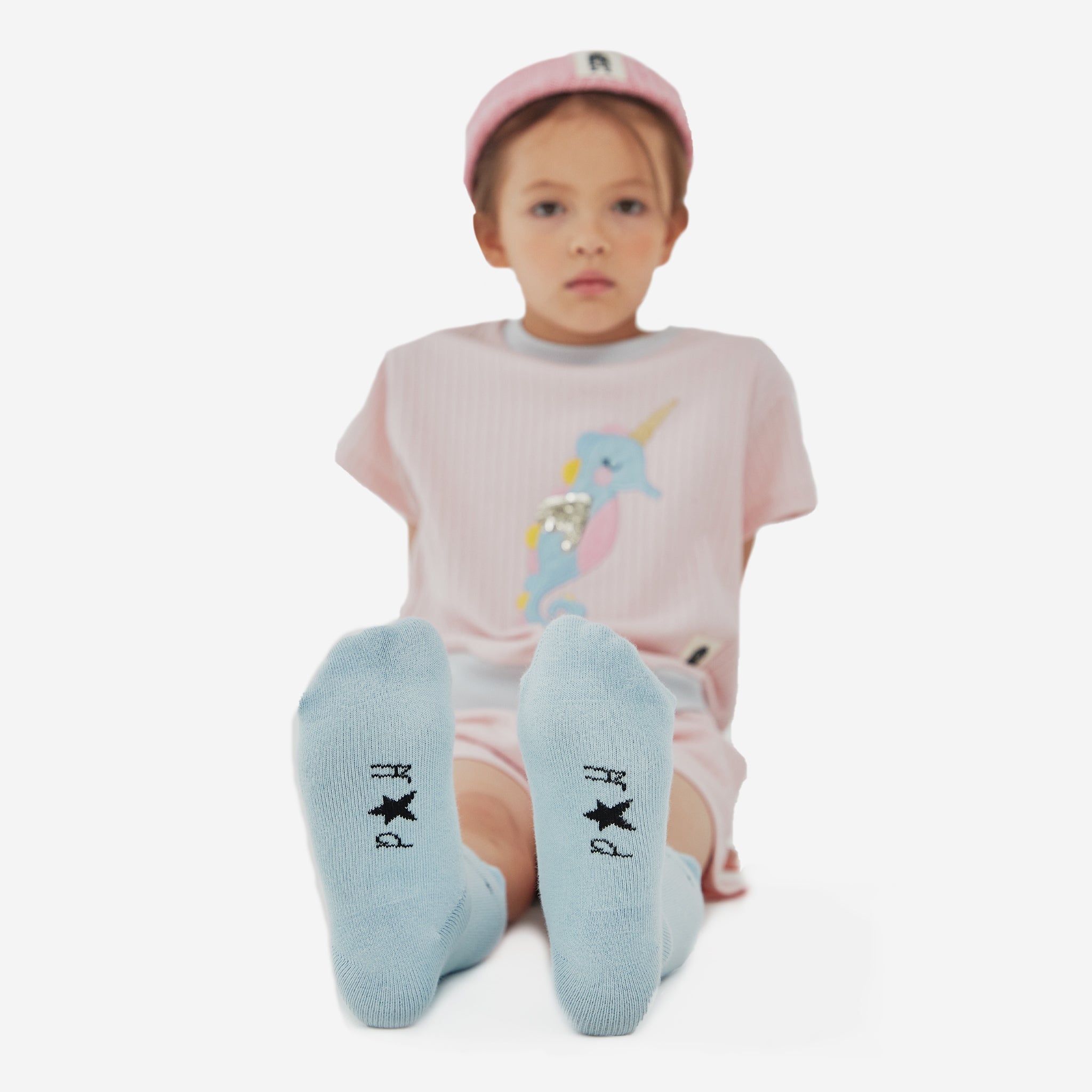 knitted pink hat with black ph play logo on white background