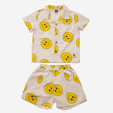 yellow smiley faces on cream background set includes short sleeves top with buttons on the front and a short 