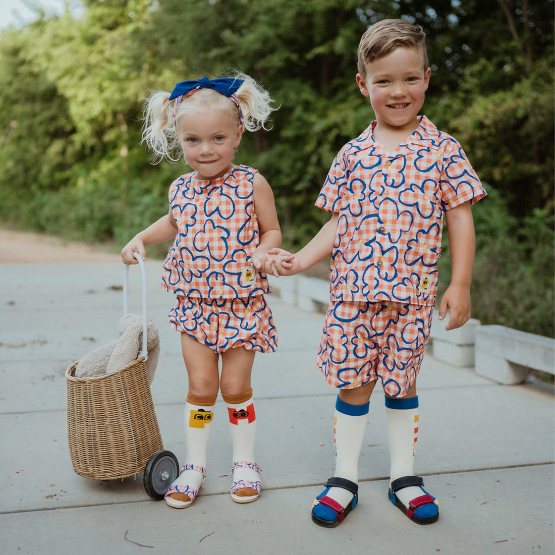 orange checker with blue flowers set includes short sleeves top with buttons on the front and a short 