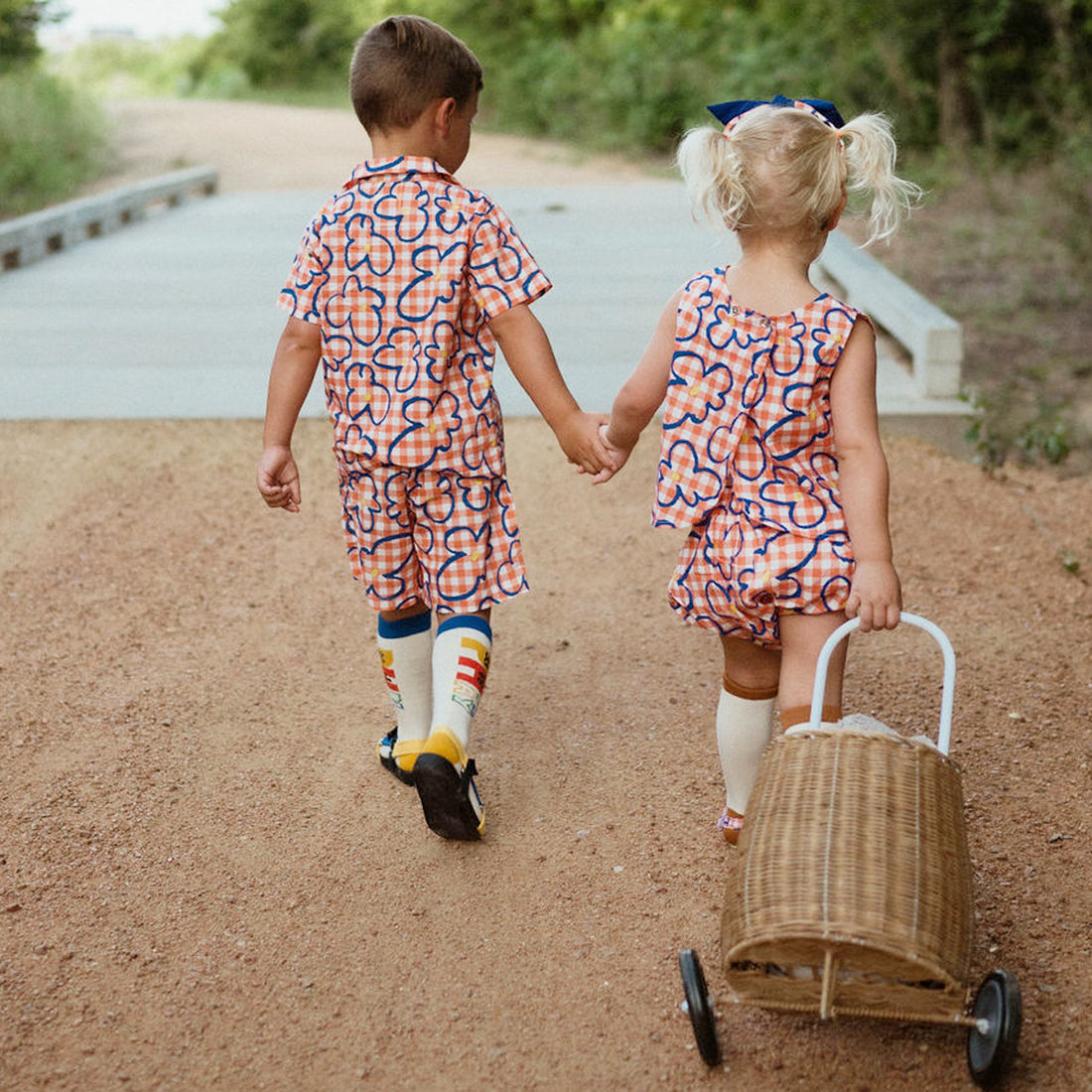 orange checker with blue flowers set includes short sleeves top with buttons on the front and a short 