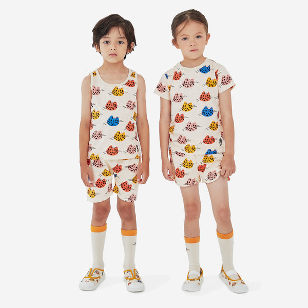 The multi cat print boy short has a cream background with abstract multi color cat faces and elastic belt
