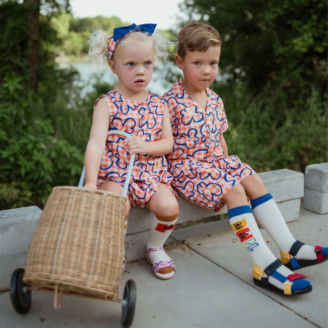 orange checker with blue flowers set includes short sleeves top with buttons on the front and a short 