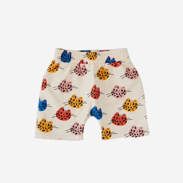 The multi cat print boy short has a cream background with abstract multi color cat faces and elastic belt
