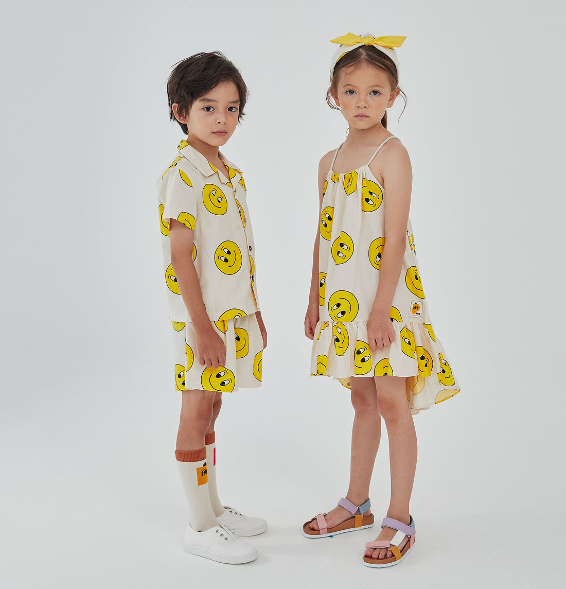 yellow smiley faces on cream background, top of the dress has adjustable robe 