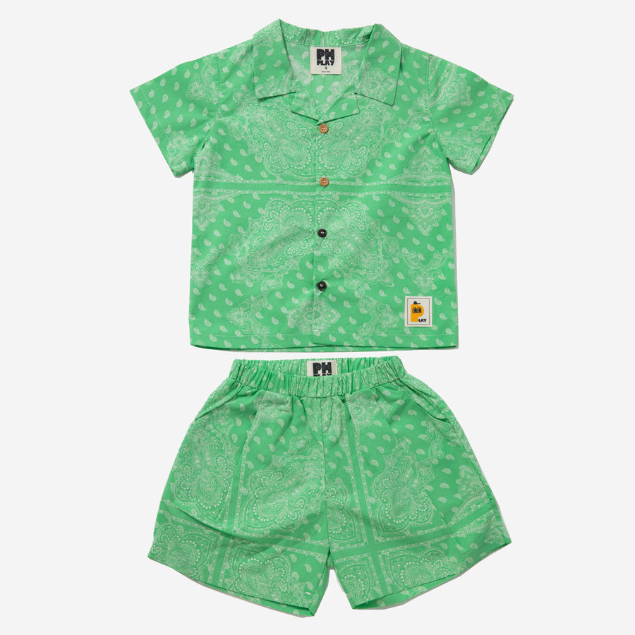 green background with white motives set includes short sleeves top with buttons on the front and a short 