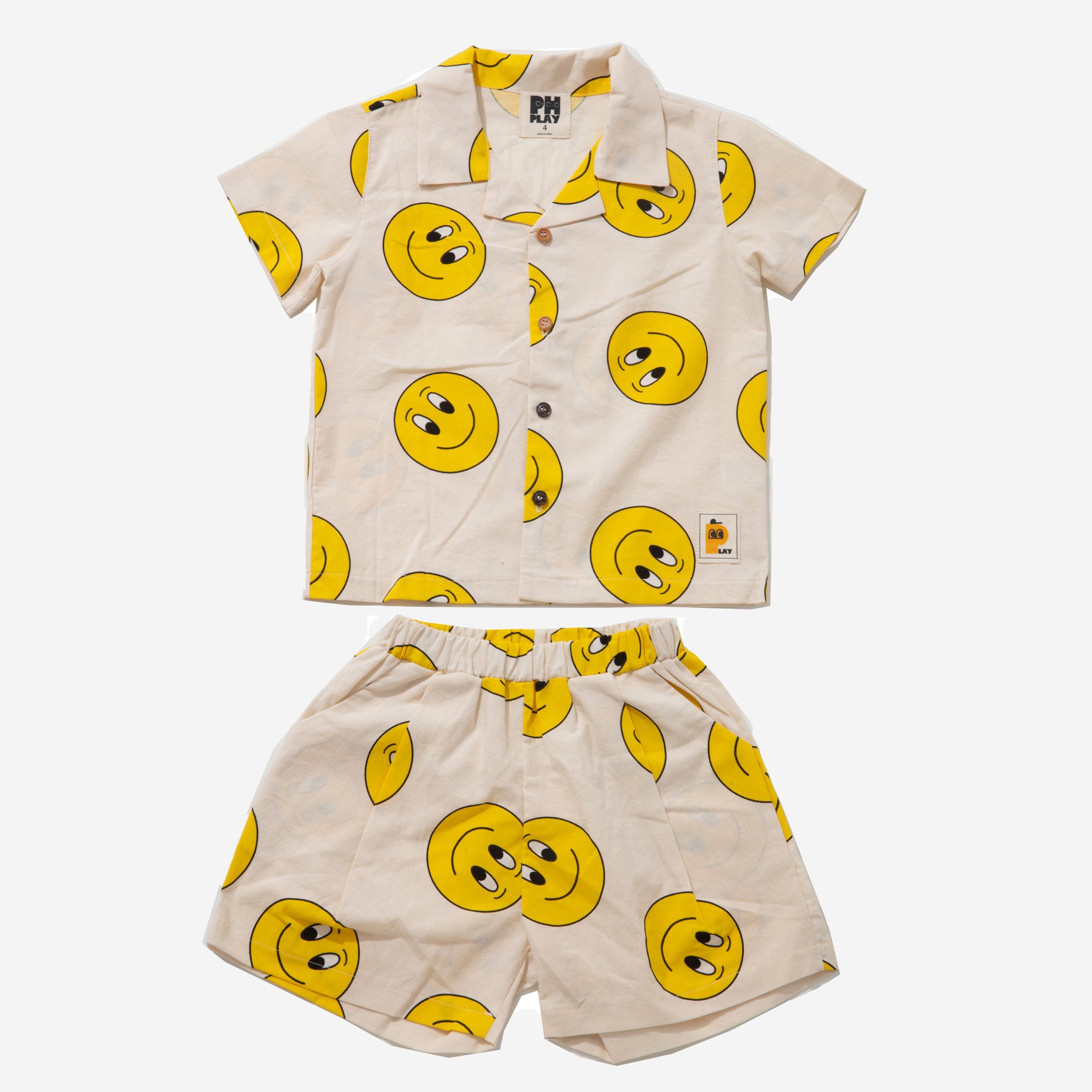yellow smiley faces on cream background set includes short sleeves top with buttons on the front and a short 